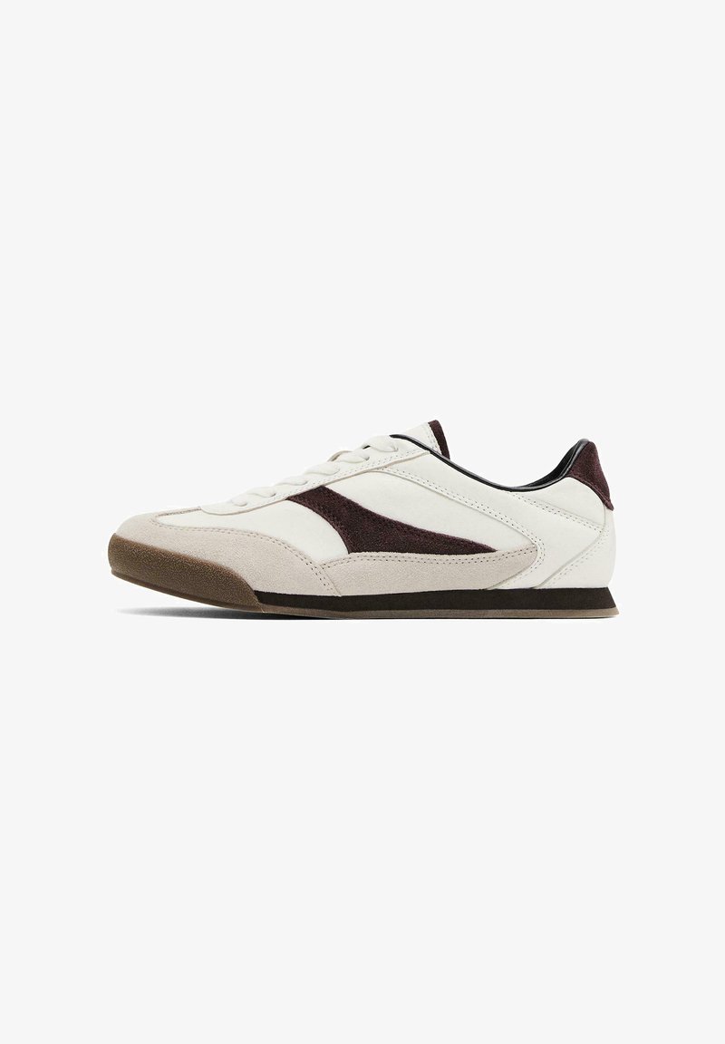 White sneaker with dark burgundy accents, suede and leather materials, rounded toe, flat brown rubber sole, and stitched detailing.