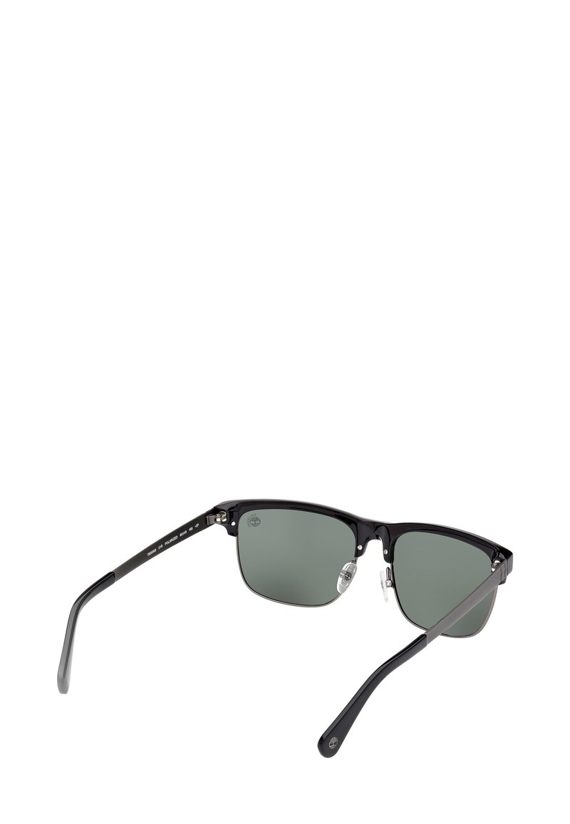 Zwarte halfrande zonnebril met rechthoekige groengetinte gepolariseerde lenzen en verstelbare neuspads, weergegeven vanuit een achterkant.