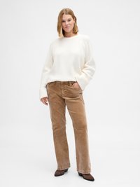 White ribbed sweater with long sleeves paired with brown corduroy trousers and brown ankle boots. Simple, casual design with relaxed fit.