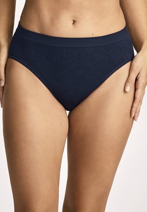 Navy blue high-waist briefs with subtle floral pattern, worn by a person shown from waist to mid-thigh against a plain background.