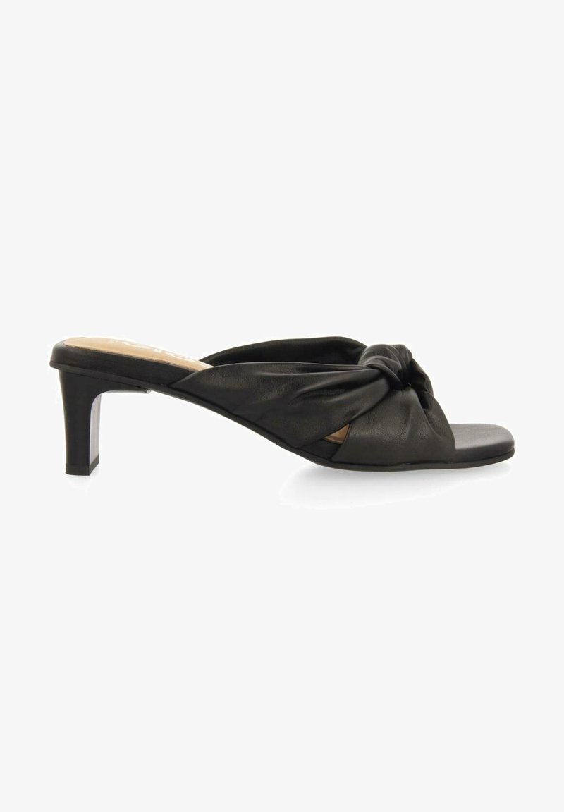 Mule noire en cuir avec bout ouvert, talon bloc bas et design de sangle nouée sur le dessus.