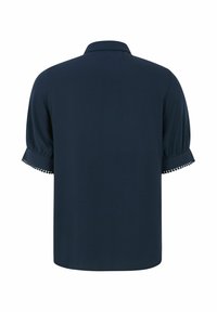 Navyblauwe blouse met korte mouwen van een zachte textuur, voorzien van een geklede kraag en decoratieve afwerking op de manchetten. Eenvoudig, losvallend ontwerp.