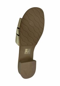 Suela de goma marrón con un patrón ondulado texturizado, que presenta un diseño de tira metálica dorada y un tacón bajo en bloque. Etiqueta de talla: 37.