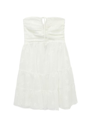 Biała sukienka bez ramiączek z marszczonym gorsetem, wielowarstwową spódnicą i subtelnymi wzorami gwiazdek na całej tkaninie.