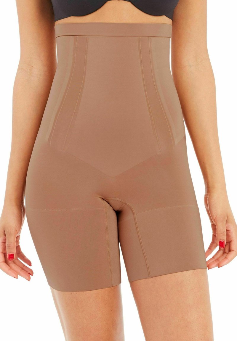 High-waisted shapewear shorts in a nude tone, made from smooth, stretchy fabric with reinforced seams and a seamless finish.