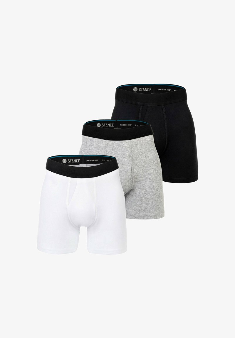Three pairs of boxer briefs in white, gray, and black, featuring a soft elastic waistband with "STANCE" branding and a snug fit design.