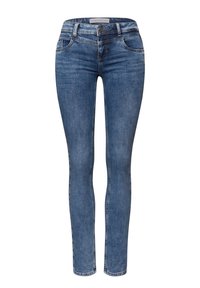 Jeans skinny de denim azul con una cintura de altura media, lazos para cinturón, bolsillos frontales y detalles de costura sutiles. Textura suave, diseño clásico.