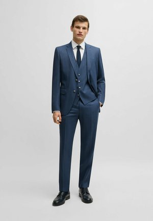 Navy blue three-piece suit with a textured finish, featuring a fitted jacket with two buttons, vest, and slim trousers. Black dress shoes.