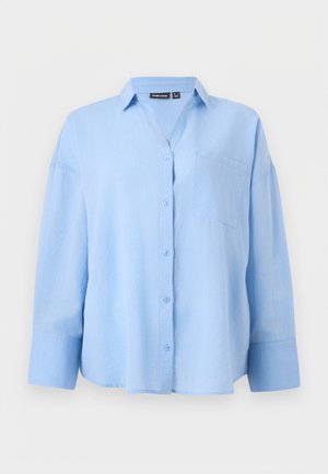 Light blue long-sleeve button-up shirt with a collar and chest pocket, displayed on a plain light background.
