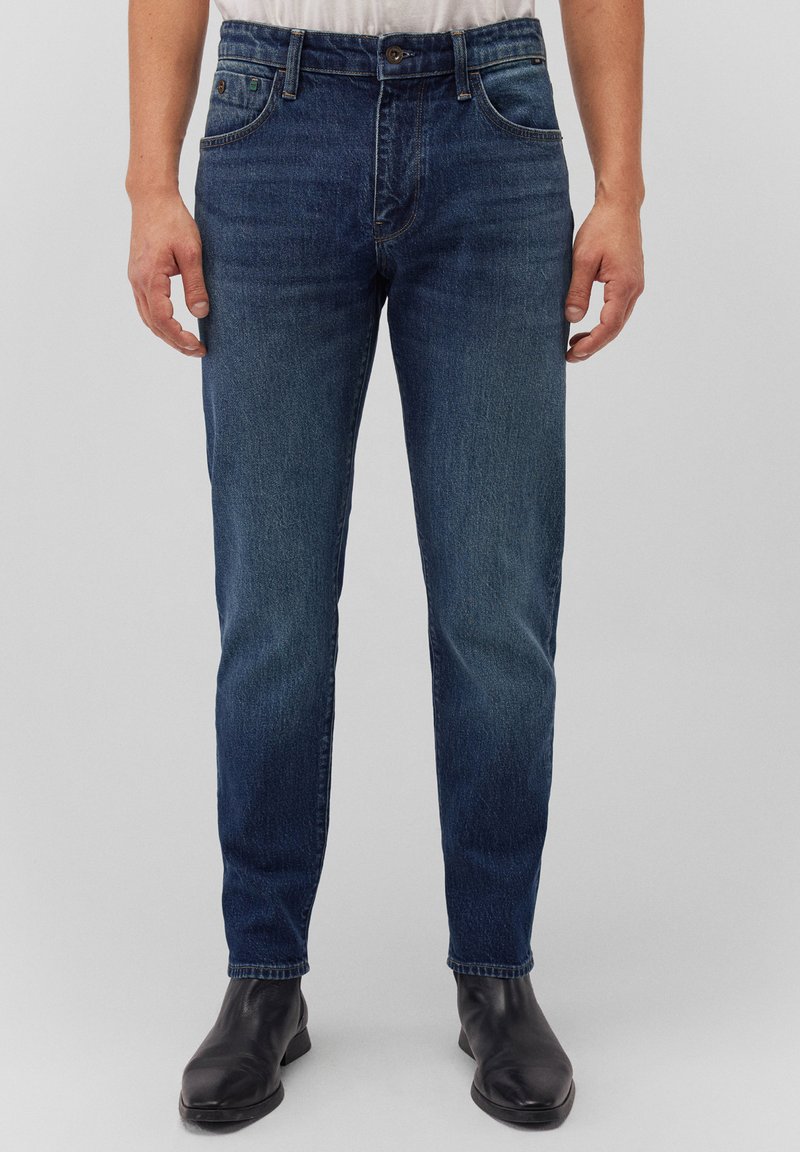 Dark blue denim jeans with a straight cut, five pockets, and a button closure, featuring slight fading on the thighs and a smooth texture.
