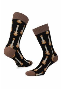 Czarne skarpetki z powtarzającym się wzorem gitar w beżowych i brązowych odcieniach, z jednolitym brązowym mankietem i wzmocnieniem palców.