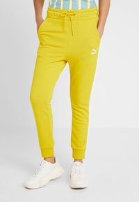 Puma Pantalones deportivos - mustard yellow