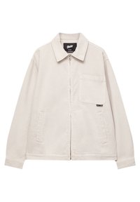 Beige jakke med frontlynlås, lange ærmer, krave, sidelommer og en brystlomme. Lavet af stof med en glat tekstur.
