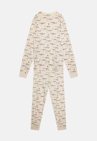Ensemble de pyjama à manches longues en tissu beige avec un motif de dinosaures répétitif en gris foncé. Texture douce, design ajusté et poignets côtelés.
