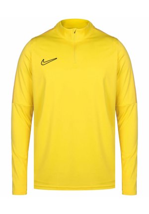 Maglietta sportiva gialla a maniche lunghe con colletto a mezza zip, realizzata in tessuto morbido e leggero; presenta un logo Nike nero sul petto.