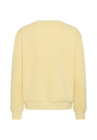 Sweat-shirt uni jaune clair vu de dos, manches longues, poignets et ourlet côtelés, sans motifs ni logos visibles.