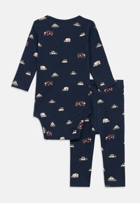 Σαλονάκι σε ναυτικό χρώμα για παιδιά, αποτελούμενο από μακρυμάνικο μπλουζάκι και παντελόνι, διακοσμημένο με διάφορα εκτυπώματα οχημάτων σε ανοιχτά χρώματα επάνω σε ραμμένο ύφασμα.