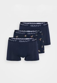 Three pairs of men's boxer briefs in dark blue fabric with a smooth texture. Two pairs are solid navy, one features a bird print. Elastic waistbands.