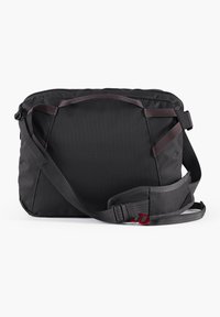 Black messenger bag with a textured surface, featuring a wide adjustable strap, red accents, and a zippered top closure.