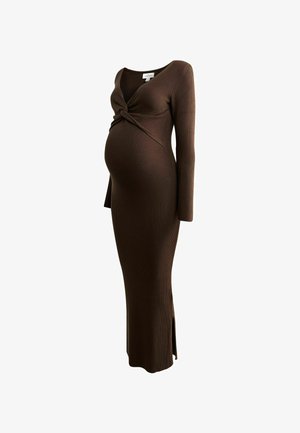 Robe de maternité marron à côtes avec manches longues, design avant torsadé et fente latérale. Fabriquée dans un tissu extensible pour le confort.