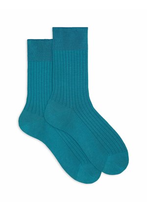 Calzini in cotone color teal con texture a coste, caratterizzati da un design a tinta unita e un rinforzo nelle punte e nei talloni per garantire durata. Coppia di lunghezza standard.