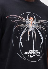 Black shirt with abstract insect-like design in white and orange, and white "Nike Running" text with Nike swoosh logo below.