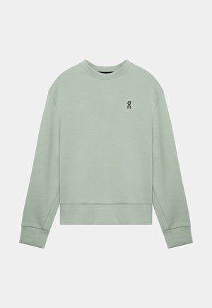Bluză sport cu mâneci lungi, de culoare verde deschis, cu guler rotund, cu un mic logo negru "on" pe partea stângă a pieptului, manșete și tiv striate.