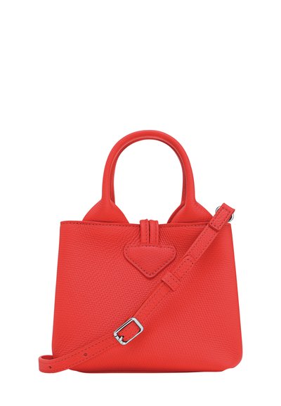 Red textured leather handbag with double handles and an adjustable shoulder strap, shown against a white background.