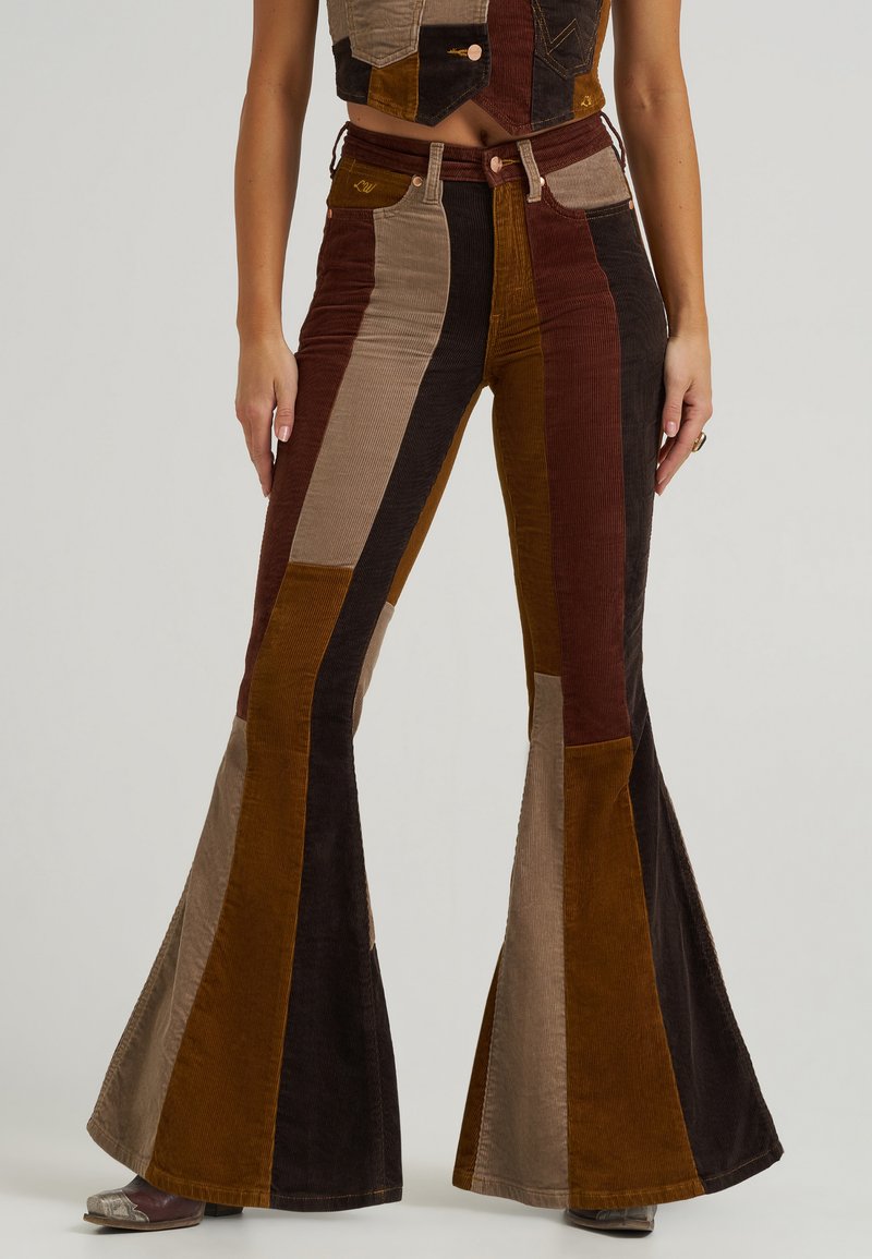Corduroy flared pants with vertical color blocks in brown, tan, and rust. Features a high waist and a classic five-pocket design.