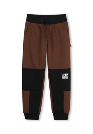 Pantalon de jogging marron et noir avec taille élastique, cordon, poches latérales, poignets côtelés aux chevilles et logo blanc sur la jambe droite.