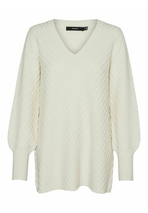 Helle gestrickte Pullover in Cremefarbe mit V-Ausschnitt, der ein strukturiertes Zickzackmuster und voluminöse Ärmel mit gerippten Bündchen aufweist.