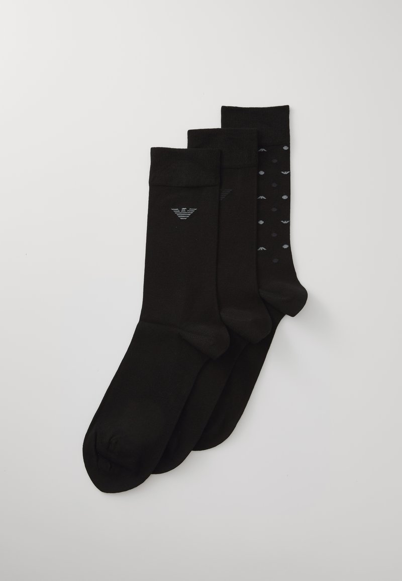 Three pairs of black socks featuring a solid design and a patterned style with small grey dots, made of a soft, stretchy material.
