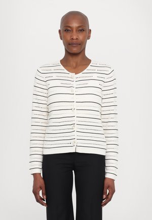Valkoinen neuletakki, jossa on mustat va horizontal stripes. Ominaisuuksina pyöreä kaula-aukko, napit edessä ja teksturoitu neulekuvio. Pitkät hihat.