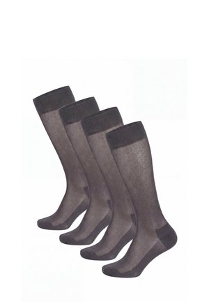 Quattro paia di calzini neri trasparenti al ginocchio con punta e polsino rinforzati, disposti fianco a fianco su sfondo bianco.