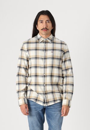Beige og brun rutet skjorte med knapper og lange ærmer, skjortekrave og brystlomme. Lavet af blødt, tekstureret stof.