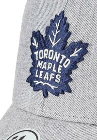 Gray cap featuring a textured fabric and a navy blue embroidered maple leaf logo with "Toronto Maple Leafs" in white.