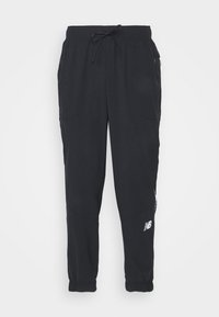 Black athletic pants with an elastic waistband, drawstring, and zippered side pockets. Features a white logo on the left leg.