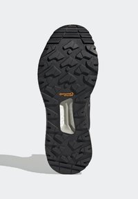 Semelle de bottine noire avec des crampons profonds, logo Continental WinterGrip et rembourrage blanc visible au centre de la semelle intermédiaire.