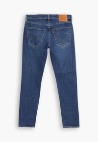 Dunkelblaue Jeans aus Denim mit geradem Bein, ausgestattet mit zwei Gesäßtaschen und einem Lederlabel am Bund. Strukturierter Stoff.