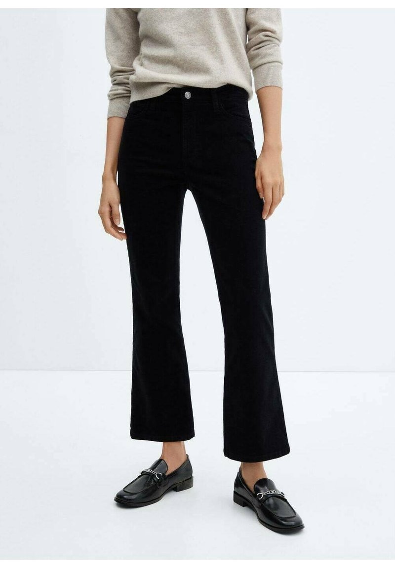 Black corduroy flared pants with a high waist, featuring a front button closure and pockets. Smooth texture and classic cut.