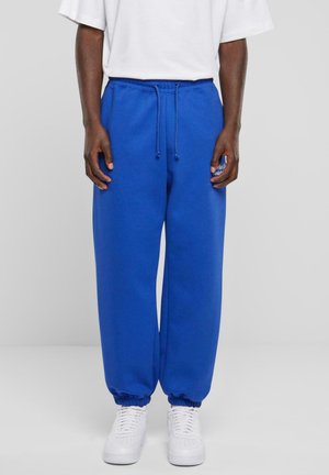 Blaue Baumwoll-Sweatpants mit elastischem Bund, verstellbarem Kordelzug und elastischen Bündchen; mit einem kleinen bedruckten Logo auf dem Oberschenkel.