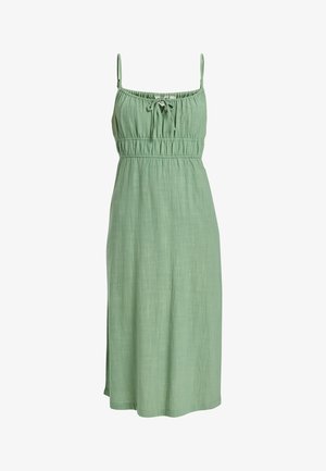Grøn linnedkjole med tynde stropper, samlet talje og en bindedetalje ved halsen, der når midt på læggen med en glat tekstur.