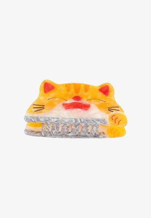 Pomarańczowo-biały plastikowy klips do włosów w kształcie twarzy kota, z uszami, wąsami oraz fakturowanym uchwytem z metalowymi ząbkami.