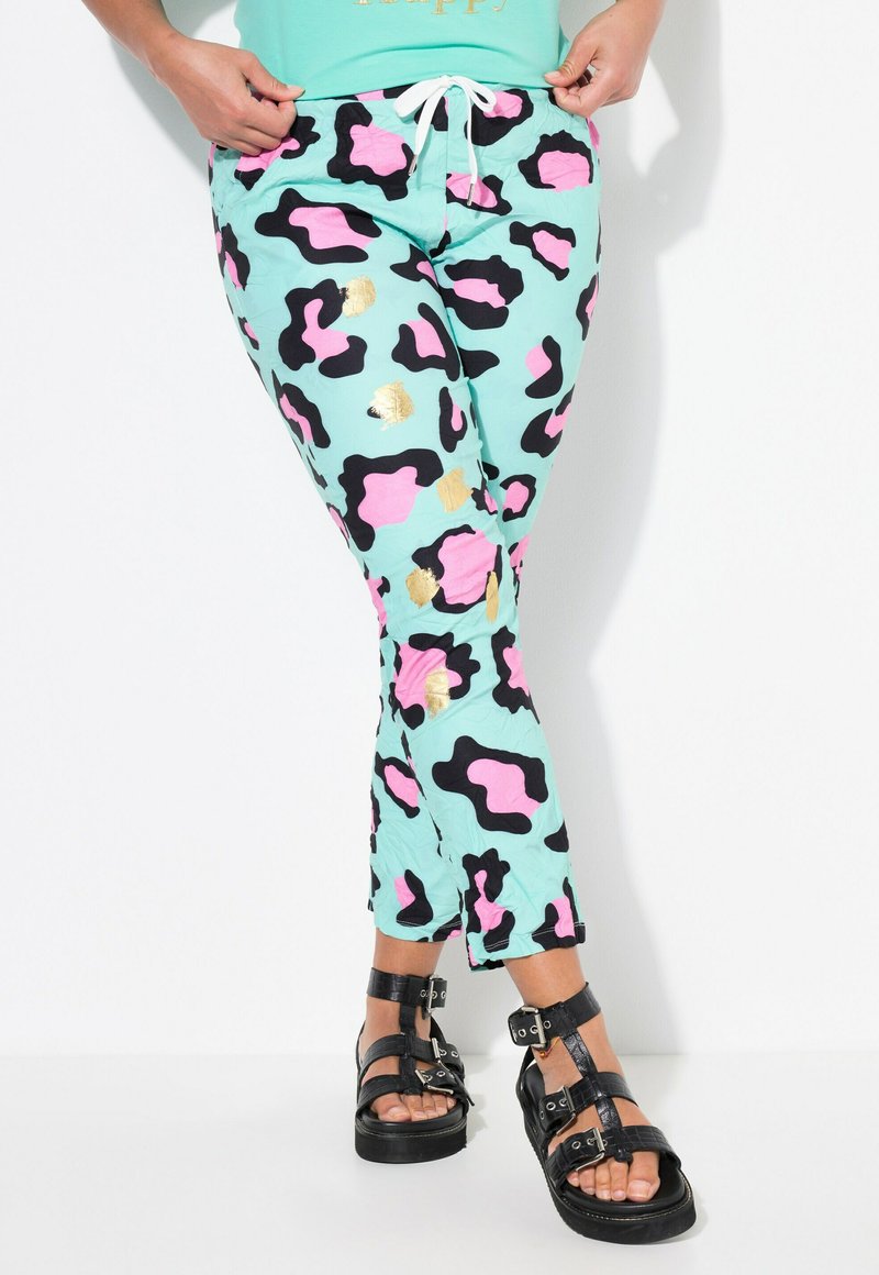 Lightweight mint pants featuring a bold black, pink, and gold leopard print pattern. Finished with a drawstring waist and tapered design.