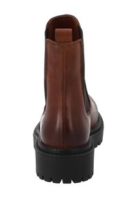 Stivaletti Chelsea in pelle marrone con punta rotonda, pannelli laterali elasticizzati e una robusta suola in gomma nera con battistrada decorato.