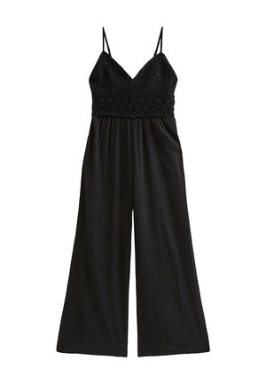 Tuta nera con sottili spalline a spaghetti, corpino lavorato a uncinetto e pantaloni a gamba larga realizzati in tessuto morbido e strutturato.