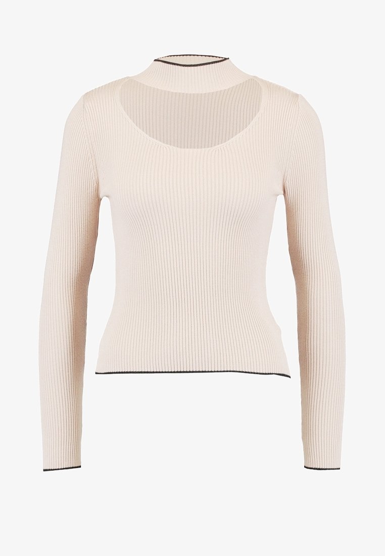 Haut à manches longues côtelé de couleur beige clair, avec un col rond et un dos ouvert, orné de bordures contrastantes noires.