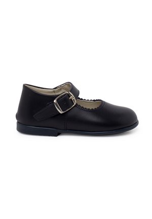 Black leather Mary Jane shoe with a round toe, scalloped edge, and a single adjustable strap featuring a silver buckle. Flat sole.