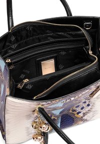 Spalvota rankinė su tekstūruota, roplių odą primenančia išore violetinės, mėlynos ir auksinės spalvų akcentais. Turi kelias skyrių ir užtrauktukus.