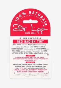 Red packaging with white text, featuring "100% NATURAL" and "SUPERFOOD RED RADISH TINT" prominently. Lists uses and ingredients in clear layout.